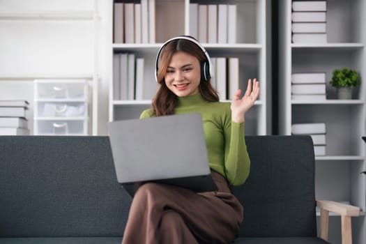 Portrait of young woman with using her laptop compute on video call with family or friends happily.