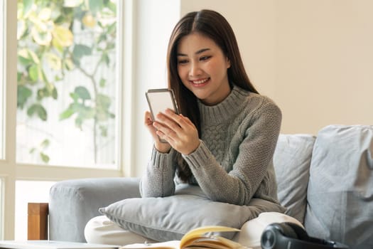 Happy teen girl holding cell phone using smartphone device at home. subscribing new social media, buying in internet, ordering products online in apps.