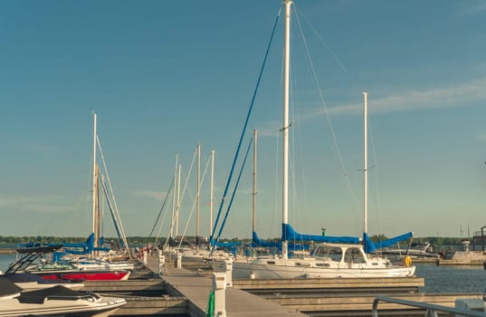 In the evening, sailing yachts are moored in the bay