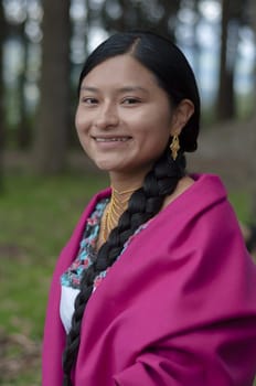 close-up of indigenous girl smiling at camera with a fuchsia cloak. High quality photo
