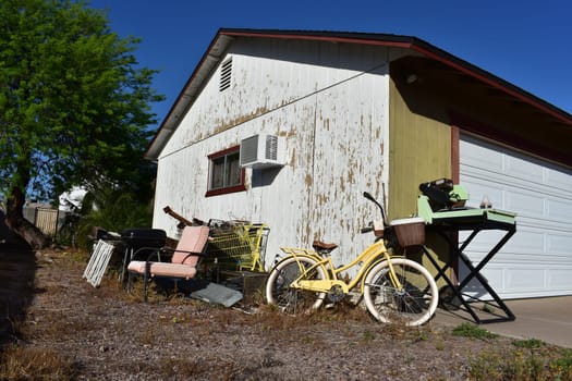 Bunch of Junk Near Garage with Peeling Paint. High quality photo