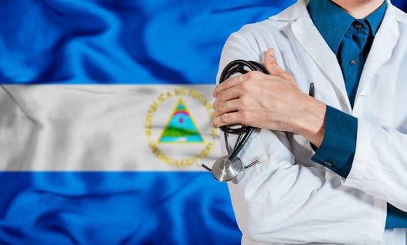 Health and care with the flag of Nicaragua. Nicaragua national health concept, Doctor arm holding stethoscope on nicaragua flag. Doctor with stethoscope on Nicaragua flag