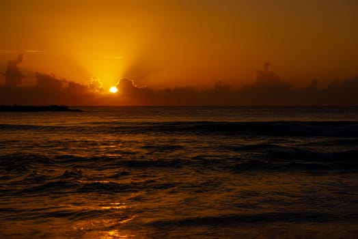 Sea beach with sky sunset or sunrise. Clouds over the sunset sea. Sunset at tropical beach. Nature sunset landscape of beautiful tropical sea.