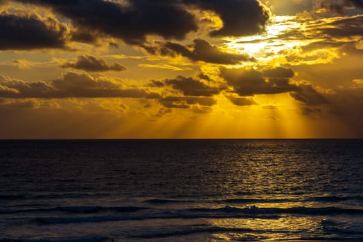 Sea beach with sky sunset or sunrise. Clouds over the sunset sea. Sunset at tropical beach. Nature sunset landscape of beautiful tropical sea.