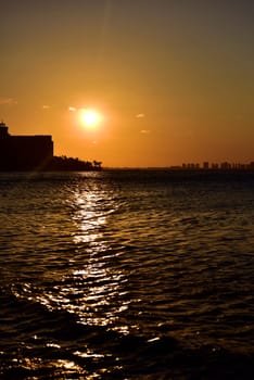 Sunrise or sunrise overlooking the sea and a line of hotels