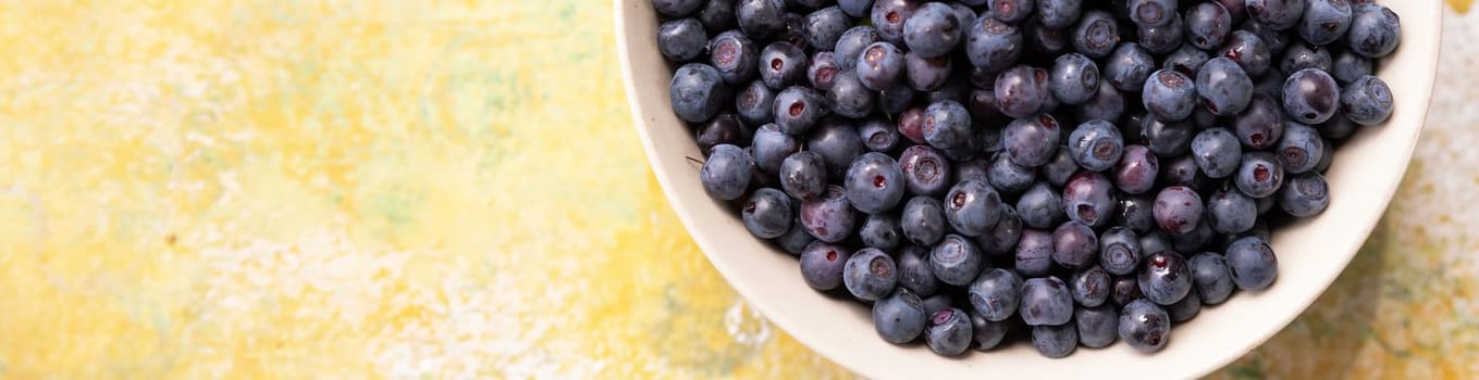 Forest berries blueberry,bramble in a ceramic bowl.Top view.