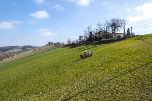 farmer driving uphill crawled tractor in the farm during spring season