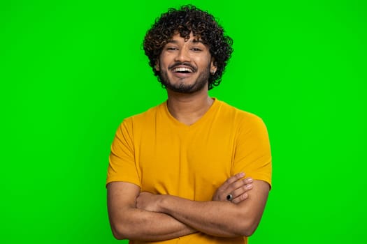 Portrait of happy calm indian man smiling friendly, glad expression looking away dreaming resting, relaxation feel satisfied concept good news, celebrate win. Hindu guy on green chroma key background
