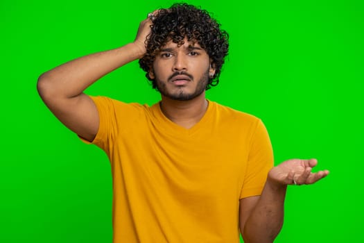 Bearded indian man feeling hopelessness loneliness, nervous breakdown, loses becoming surprised by lottery results, bad fortune, loss, unlucky news. Hindu young guy isolated on chroma key background