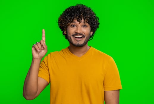 Eureka. Inspired young indian man pointing finger up with open mouth, having good idea, plan, startup, showing inspiration motivation gesture, problem solution. Hindu guy on chroma key background