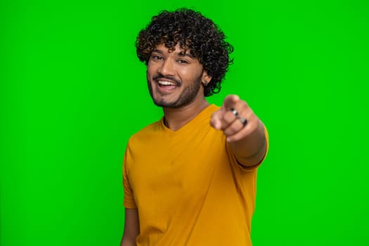 Amused bearded indian man pointing finger to camera, laughing out loud, taunting making fun of ridiculous appearance, funny joke anecdote. Handsome hindu guy isolated on green chroma key background