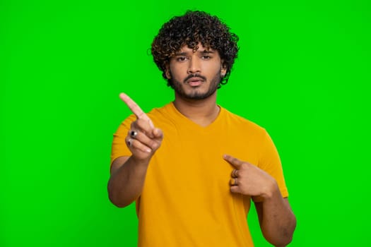 I am dont want it, not me. Confused young indian man pointing fingers hisself ask say who why me no thanks i do not need it, rejection, refusal, stop sign. Hindu guy isolated on chroma key background