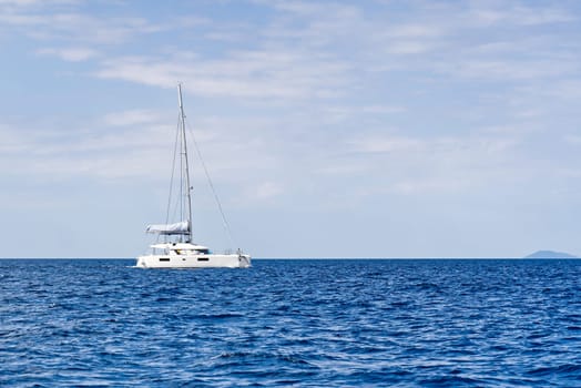 Yacht catamaran on the sea. Catamaran sailing on turquoise waters. Holiday or vacation at sea. Luxury yachts. summer