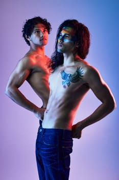 Skin, creativity and body of men model for beauty with paint as artwork isolated in a purple studio background. Colorful, neon and creative people for artistic beauty or fashion in a backdrop.