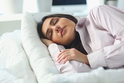 Portrait of beautiful woman sleeping serenely in bed. Calm healthy sleep concept