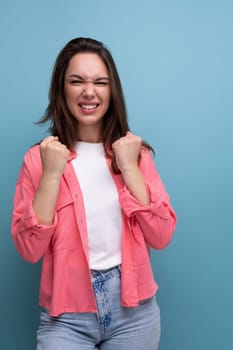 successful joyful brunette woman with hair below her shoulders in a shirt.