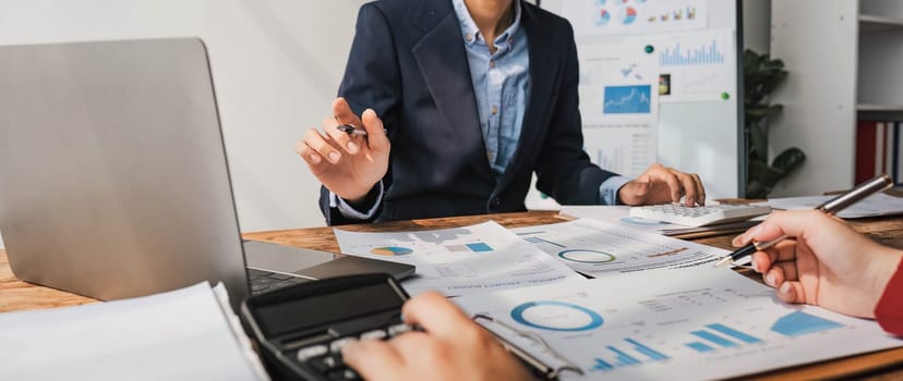 Business People Meeting using laptop computer,calculator,notebook,stock market chart paper for analysis Plans to improve quality next month. Conference Discussion Corporate Concept