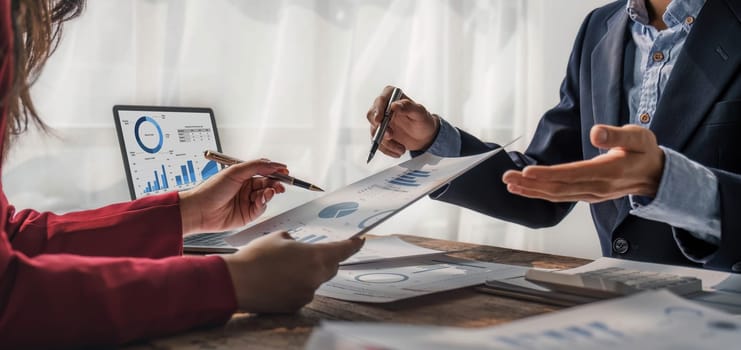 Business People Meeting using laptop computer,calculator,notebook,stock market chart paper for analysis Plans to improve quality next month. Conference Discussion Corporate Concept