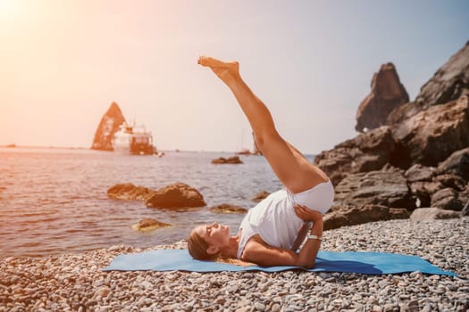 Woman sea yoga. Back view of free calm happy satisfied woman with long hair standing on top rock with yoga position against of sky by the sea. Healthy lifestyle outdoors in nature, fitness concept.