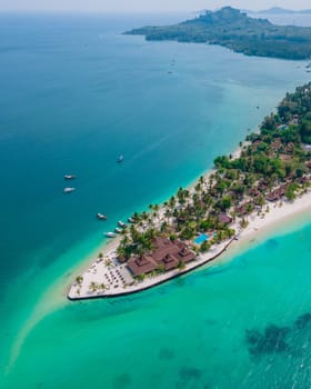 Koh Mook tropical Island in the Andaman Sea in Thailand, tropical beach with white sand and turqouse colored ocean with coconut palm trees.