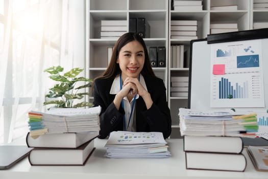 Happy business lady using laptop smiling to camera posing working sitting at workplace In office. successful entrepreneurship and career concept.