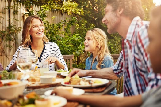 Nothing more important than family. a family eating lunch together outdoors