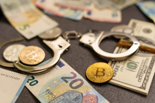 Bitcoins and handcuffs as an abstract symbol of crime that can hide a crypto currency