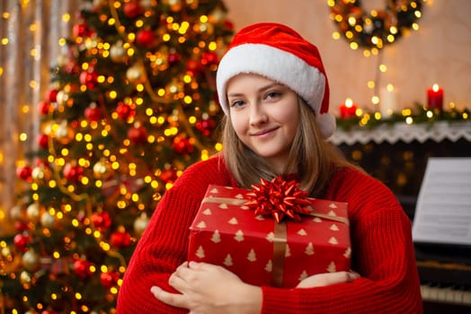 Decorated Christmas tree and garland lights on the background, cosy atmosphere at home, merry Christmas and happy New Year concept