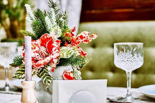 the annual Christian festival celebrating Christ's birth, held on December 25 in the Western Church. Festive New Year's Christmas table with candles and dishes close up. High quality photo