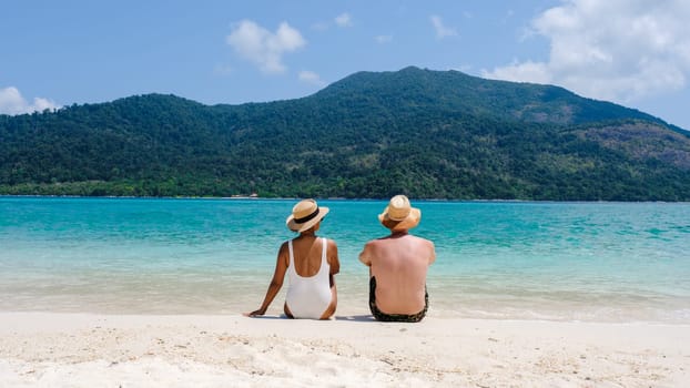 Couple on the beach of Koh Lipe Island Thailand, a tropical Island with a blue ocean and white soft sand. Ko Lipe Island Thailand