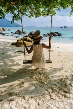 Asia women on vacation at Koh Lipe Island Thailand, a tropical Island with a blue ocean and white soft sand. Ko Lipe Island Thailand