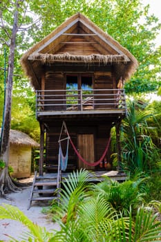 Bungalow on the beach of an Island in Thailand, wooden villa on the beach with palm trees