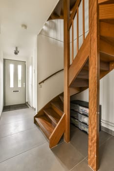 a room with stairs and a television set on the floor in front of the staircases that leads up to the second floor