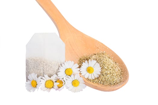Dry chamomile tea flower petals in wooden spoon isolated on white background.