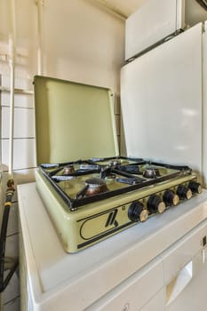 an old stove and refrigerator in a room with no one on the stove top, but it's white