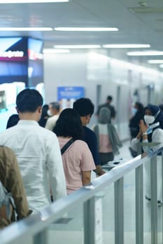 Friendly female officer greeting the passengers at the entry gate at MRT Station, Jakarta. Indonesia. April 20, 2023. Public service photography.