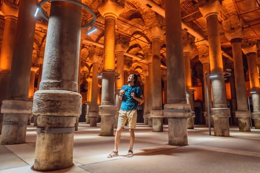 Man tourist enjoying Beautiful cistern in Istanbul. Cistern - underground water reservoir build in 6th century, Istanbul, Turkey, Turkiye.