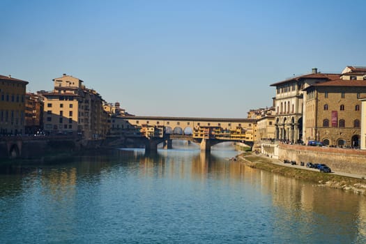 Florence, Italy - 12.02.2023: View of the famous Ponte alle Grazie bridge and the Arno river in Florence. High quality photo