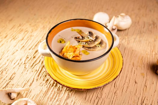 mushroom soup in a plate on the table in a cafe.