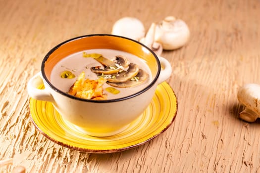 mushroom soup in a plate on the table in a restaurant.