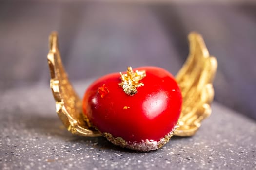 red dessert in the shape of a heart with wings.