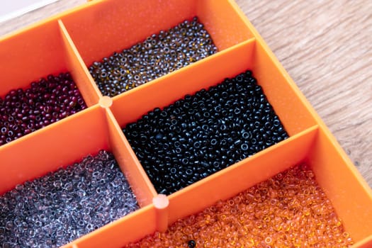 Colorful beads in containers close up, handicrafts, macrophoto