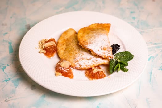 sweet berry cheburek with jam, ice cream and strawberries.