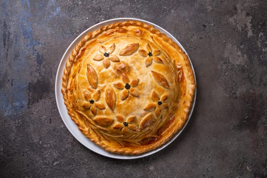 top view of a hot homemade chicken pie with filling. pie on the table.