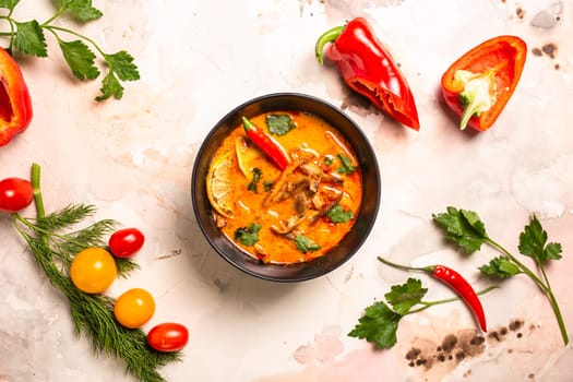 spicy tom yam soup with hot pepper and seafood top view.