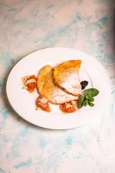 sweet berry cheburek with jam, ice cream and strawberries Top view.