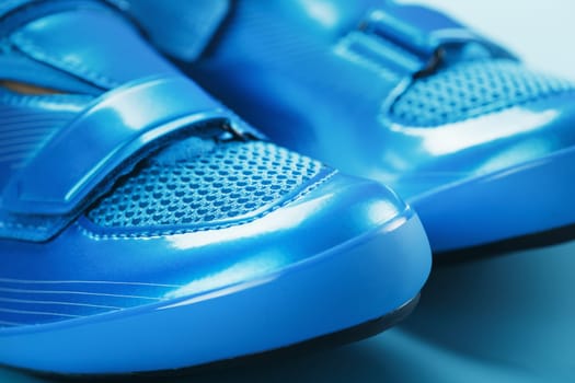 Blue Shiny Bicycle Shoes for Road Bike on Blue Background