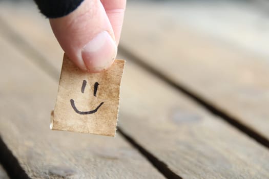 Smiley face on old wooden background, copy space.