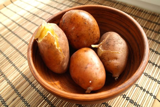 potatoes in bowl on wooden table with copy space, top view
