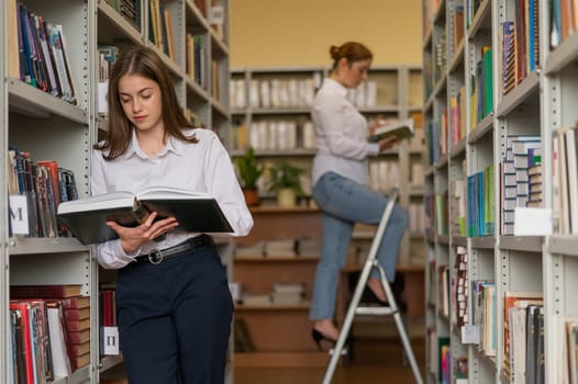 Two young female students in a public library